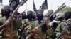 FILE PHOTO - Al-Shabab fighters march with their guns during military exercises on the outskirts of Mogadishu on March 4, 2012.