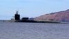 FILE - A U.S. Navy crew stands on the USS Michigan, an Ohio-class guided-missile submarine, as it prepares to dock at Subic Freeport, a former US naval base west of Manila, Philippines, March 25, 2014. The sub was on a routine port call. 