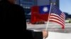 FILE - A demonstrator holds flags of Taiwan and the United States in support of Taiwanese President Tsai Ing-wen during an stopover after her visit to Latin America in Burlingame, Calif., Jan. 14, 2017.