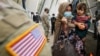 FILE - Afghan refugees board a bus taking them to a processing center upon their arrival at Dulles International Airport in Dulles, Virginia, Sept. 1, 2021. 