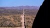 FILE - In this May 19, 2021 photo the border wall stretches along the landscape near Sasabe, Ariz. The bodies of an unusually large number of migrants who died in Arizona's borderlands are being recovered this summer amid record temperatures.