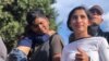 A Honduran family traveling with the caravan joined the group as they approached the pedestrian crossing with their child, Nov. 22, 2018. Celia Mendoza/VOA