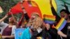 FILE - Participants displays a rainbow flag and cheer as gay rights activists and their supporters march during a gay pride parade in New Delhi, India, Nov. 12, 2017.