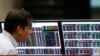 FILE - A stockbroker looks on his monitors inside the Philippine Stock Exchange (PSE) in Makati city, metro Manila, Feb. 29, 2016. 