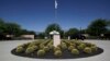 FILE - A security guard talks to a visitor at the entrance to the Annenberg Retreat at Sunnylands in Rancho Mirage, Calif., Wednesday, June 5, 2013.