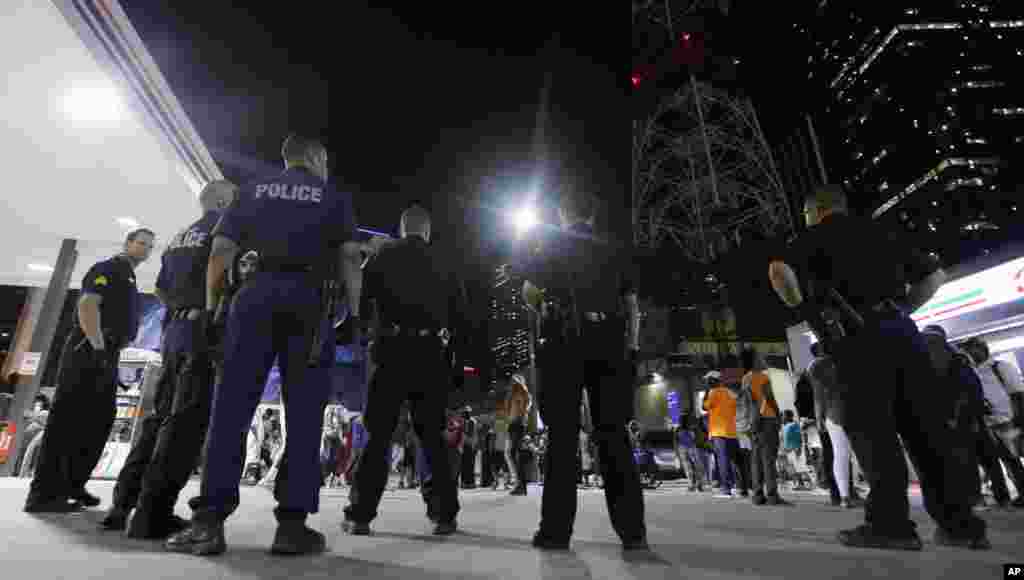 Des policiers prennent position alors qu’une foule se forme dans le centre de Dallas, 8 juillet 2016. (AP Photo / LM Otero)