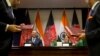 Afghanistan Foreign Minister Salahuddin Rabbani, sitting left, and Indian External Affairs Minister Sushma Swaraj, sitting right, applaud during the exchange of agreements in New Delhi, India, Sept. 11, 2017. 