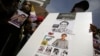 Activists hold up pictures of abducted Thai activist Wanchalearm Satsaksit as people gather in support of him during a protest calling for an investigation, in front of the Government House in Bangkok, Thailand, June 12, 2020. (REUTERS/Athit Perawongmetha)