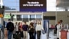 Passengers wear face masks as they arrive at the departures terminal at Sydney Domestic Airport in Sydney, Australia, Nov. 5, 2021. 