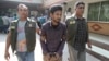 Police officers in Dhaka detain Nahid Hasan, a member of Jamaat-e-Islami, Bangladesh's biggest religion-based party, on suspicion he was involved in Islamic State propaganda, Nov. 25, 2015.
