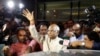 FILE - Ram Nath Kovind, center, waves to media upon arrival at the airport in New Delhi, India, June 19, 2017.