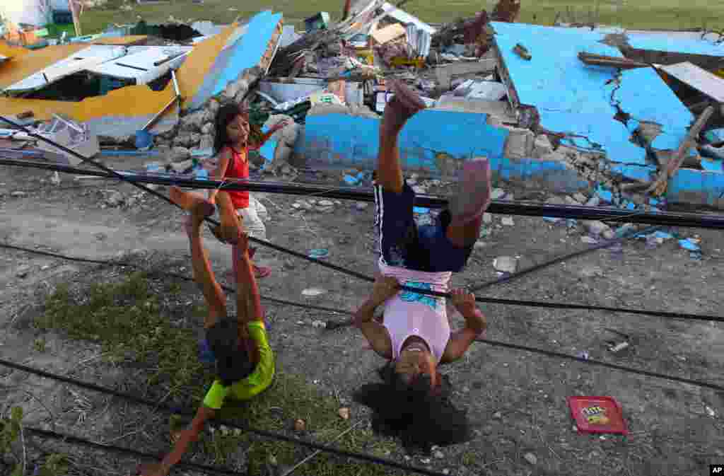Survivors of Typhoon Haiyan play with fallen power lines near a damaged school in Guiuan, Philippines, Nov. 14, 2013.&nbsp;