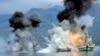 Two foreign-flagged fishing boats registered in Papua New Guinea are destroyed by the Indonesian Navy after they were seized earlier for supposedly illegal fishing off the coast of Ambon, Maluku, Dec. 21, 2014.