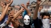 Masked Kashmiri protesters hold bricks as they shout freedom slogans in Srinagar, India, May. 27, 2017. One civilian was killed and dozens of others injured Saturday after massive anti-India protests and clashes erupted in Indian-controlled Kashmir following the killing of a prominent rebel commander and his associate.