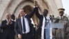 France's President Francois Hollande (2nd L) joins hands with Mali's interim president Dioncounda Traore at Independence Plaza in Bamako, Mali February 2, 2013.