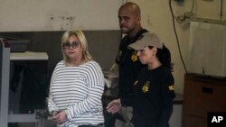 Federal agents escort former Puerto Rico Health Insurance Administration head Ángela Ávila-Marrero who was arrested in San Juan, Puerto Rico, July 10, 2019. 