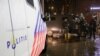 FILE - Police officers stand guard following an announcement of new measures to fight a record surge in COVID-19 infections, in The Hague, Netherlands, Nov. 26, 2021.