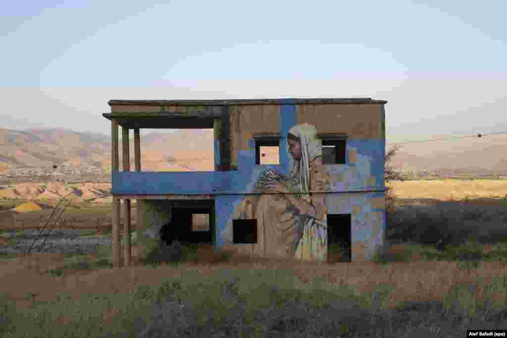 A mural by unknown artists is seen on an abandoned building that used to be a water pumphouse for water from the Jordan River, in the Jordan Valley, Israel, June 22, 2016.