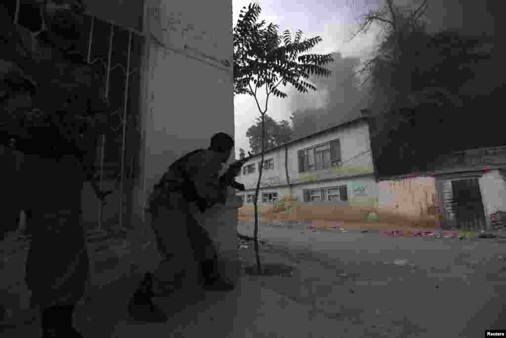 Afghan police officers near the site of an explosion in Kabul, May 24, 2013.
