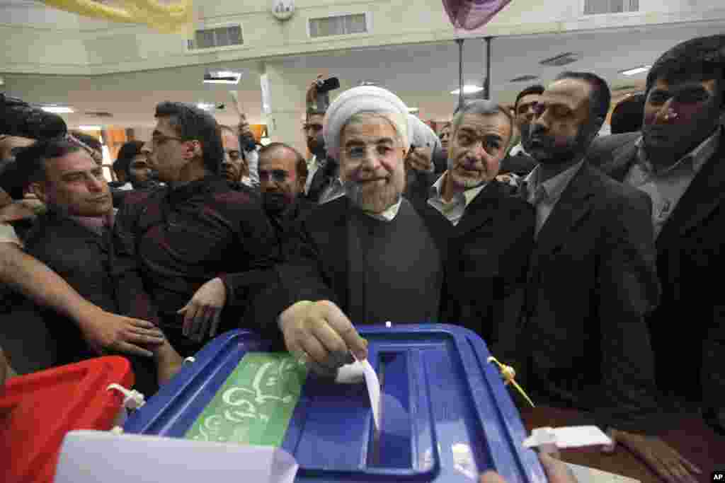 Iranian presidential candidate Hasan Rowhan casts his ballot at a polling station in downtown Tehran, June 14, 2013.
