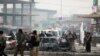 Afghan security personnel inspect the site of a bombing attack in Kabul, Afghanistan, Dec. 20, 2020.