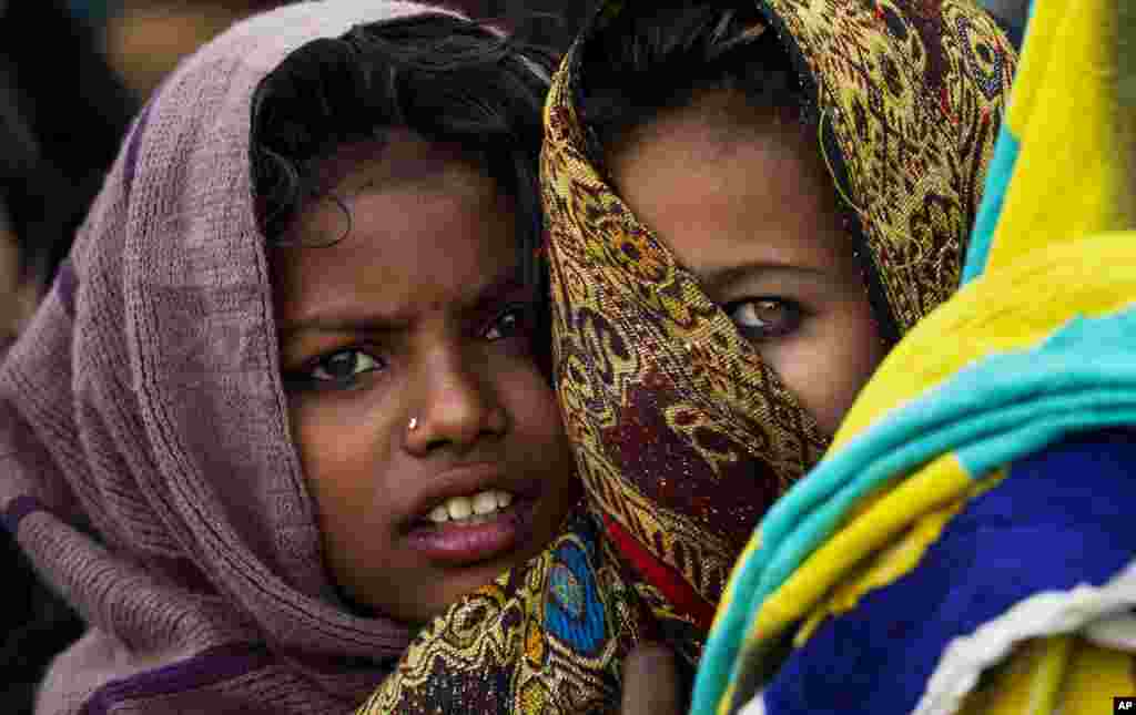 Pakistani girls wait in line to receive free food during a rally marking the birthday of Islam's Prophet Muhammad, in Rawalpindi.