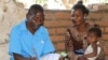 A community health worker at Mwikala district in southern Malawi, attends to a patient. Mwikala, home to over 12,000 people, has become a model village for combating malaria. (Lameck Masina/VOA)