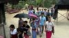 FILE - Karen refugees leave after a church service at Mae La refugee camp in Ta Song Yang district of Tak province, northern Thailand.