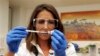 Dr Felicity Hartnell, who is a clinical research fellow at Oxford University, holds a vial of an experimental vaccine against Ebola in Oxford, England Wednesday Sept. 17, 2014. A former nurse will be the first of 60 healthy volunteers in the UK who will receive the vaccine. The vaccine was developed by the U.S. National Institutes of Health and GlaxoSmithKline and targets the Zaire strain of Ebola, the cause of the ongoing outbreak in West Africa. A trial of the same vaccine has already begun in the U.S. (AP Photo/Steve Parsons/Pool)
