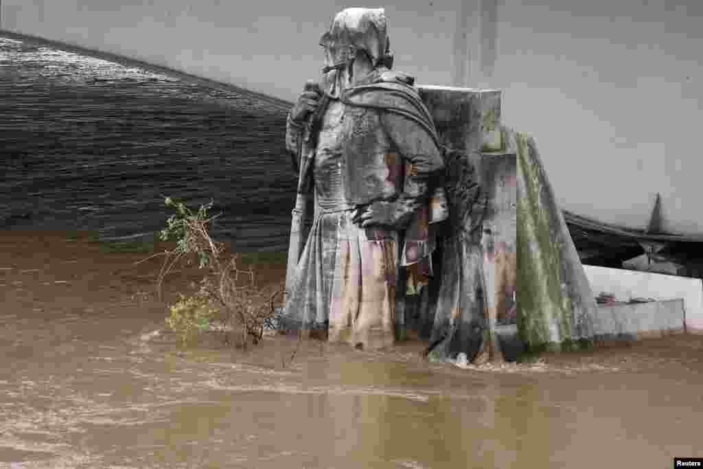 The feet of the Zouave statue on the Pont de l'Alma are covered by the rising waters from the Seine River after days of rainy weather in Paris, France as the Zouave statue is considered an indicator of the level of the Seine, when his feet are under water, emergency flood precautions are taken.