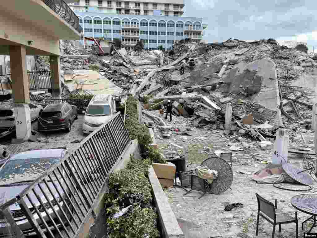 Emergency personnel work at the site of a partially collapsed building in Miami Beach, Florida.