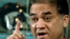 FILE - Ilham Tohti, a champion of China's Uighur minority who was jailed last year and whose plight is being highlighted by the "Press Uncuffed: Free the Press" campaign, gestures during an interview in his Beijing home, Feb. 4, 2013.