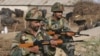 FILE - Indian army soldiers stand guard near the Indian Air Force (IAF) base at Pathankot in Punjab, India, Jan. 3, 2016. India's government has disciplined NDTV Hindi channel for related coverage, drawing media protest.
