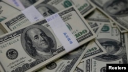 FILE - U.S. one-hundred dollar bills are shown, Aug. 2, 2013, in an illustration photo. 